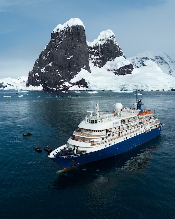 M/V Sea Spirit expedition ship in Antarctic waters surrounded by icebergs